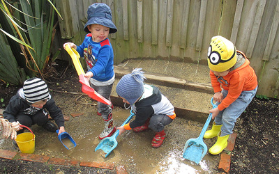 children digging in mud at daycare