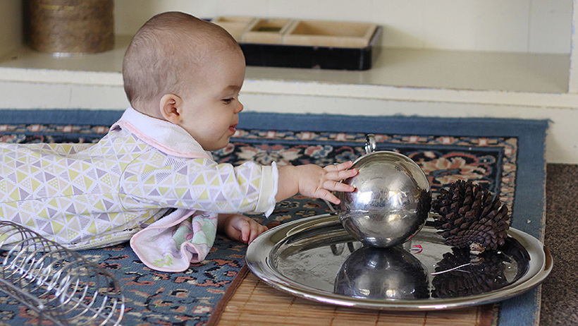 baby with ball at childcare