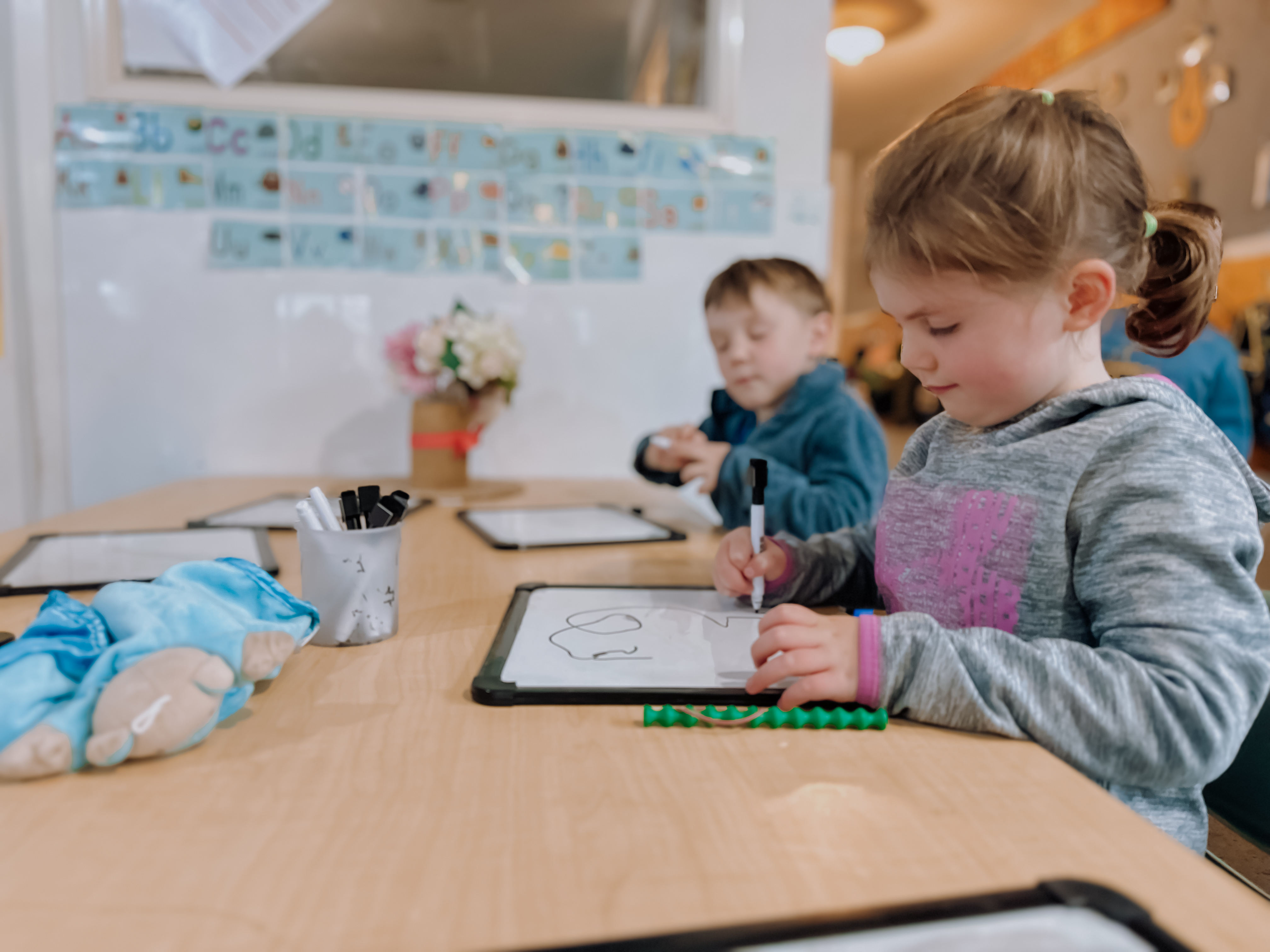 Children drawing on whiteboards at Active Explorers preschool in Ashburton